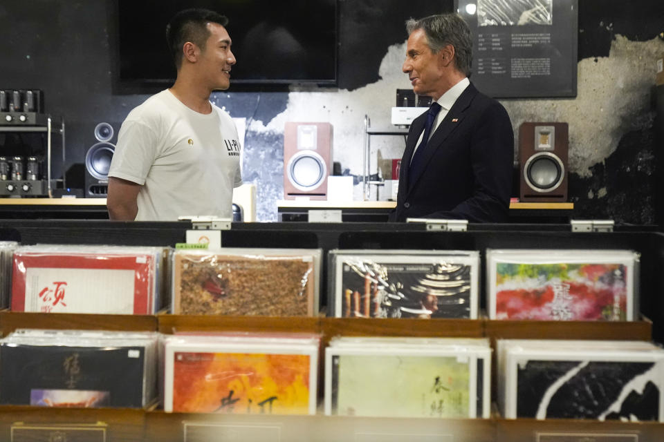 U.S. Secretary of State Antony Blinken talks with Yuxuan Zhou during a visit to Li-Pi record store in Beijing, China, Friday, April 26, 2024. (AP Photo/Mark Schiefelbein, Pool)