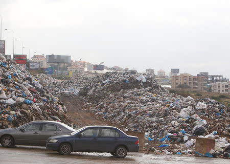 Cars pass past piled up garbage in Jiyeh, Lebanon January 28, 2018. REUTERS/Aziz Taher