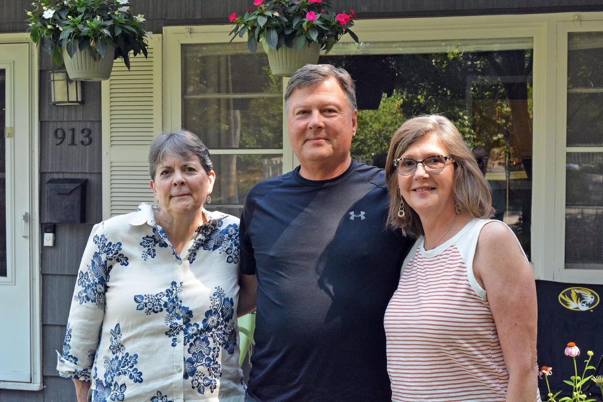 Laura Springer, left, last year bought the home on Walnut Court in which the Doak family matriarch, Grace Doak, used to live before her death in 1995. She and her cousins, Mike Doak and Pam Gray and their families gathered recently to memorialize another elder's death, Barbara Ann West, once again from the family home.