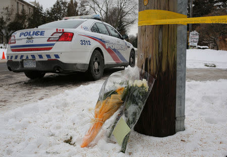 Flowers from mourners are seen outside the home of billionaire founder of Canadian pharmaceutical firm Apotex Inc., Barry Sherman and his wife Honey, who were found dead under circumstances that police described as "suspicious" in Toronto, Ontario, Canada, December 17, 2017. REUTERS/Chris Helgren