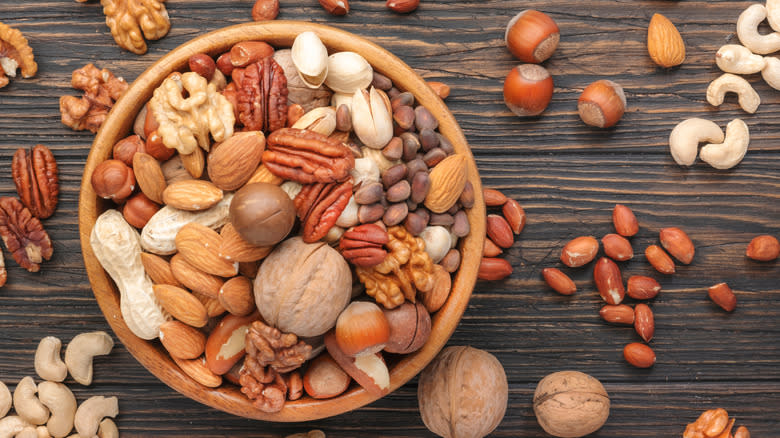 an assortment of nuts in bowl and on table