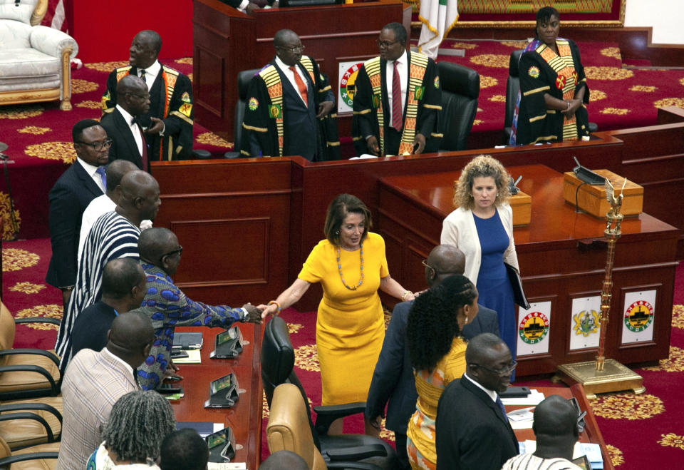 US House Speaker Nancy Pelosi shakes hands with members of Ghana's Parliament as she exits the chamber, in Accra, Ghana, Wednesday, July 31, 2019. Pelosi and other members of the U.S. Congress plan discussions on "regional security, sustainable and inclusive development and the challenges of tomorrow including the climate crisis." (AP Photo/Christian Thompson)