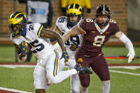 Michigan running back Hassan Haskins (25) rushes past tight end Carter Selzer (89) and Thomas Rush (8) for a touchdown in the second quarter of an NCAA college football game Saturday, Oct. 24, 2020, in Minneapolis. (AP Photo/Bruce Kluckhohn)