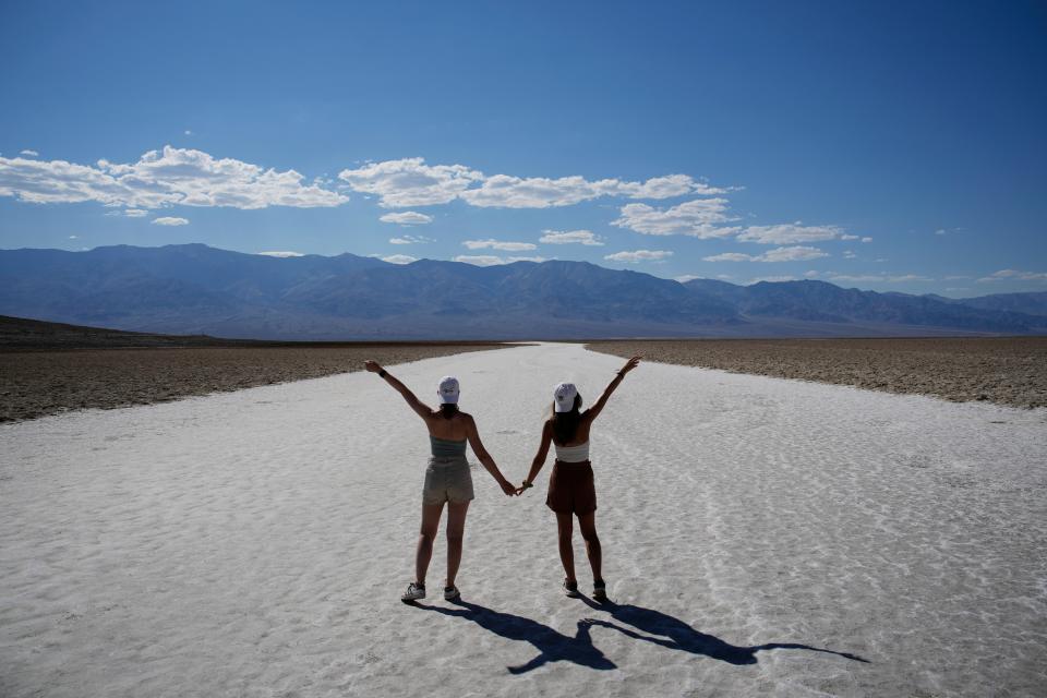 People pose for photos in Badwater Basin on Sept. 1, 2022 in Death Valley National Park.