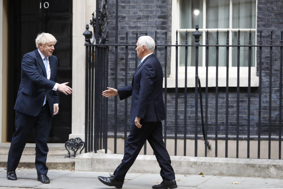 British Prime Minister Boris Johnson, left, welcomes U.S. Vice President Mike Pence prior to a meeting at Downing Street in London, Thursday, Sept. 5, 2019. (AP Photo/Alastair Grant)