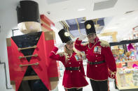 In this Tuesday, Nov. 13, 2018 photo, FAO Schwarz toy soldiers dressed in uniforms designed by model Gigi Hadid pose for a photo during a media preview of the new FAO Schwarz store at Rockefeller Center in New York. Three years after it closed its beloved toy store on Fifth Avenue, FAO Schwarz is making a return to New York opening on Friday, Nov. 16, 2018. The new version will be smaller, but will have familiar attractions, including a musical clock tower and the giant piano keyboard mat on which Tom Hanks danced in the film “Big.” (AP Photo/Mary Altaffer)