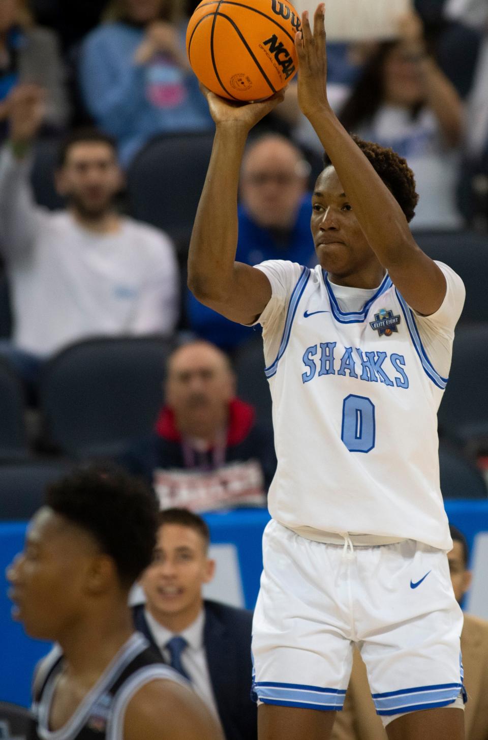 Nova Southeastern’s Jonathan Pierre (0) takes a three-point shot as the Nova Southeastern University Sharks play the Cal State San Bernardino Yotes during the semifinal round of the 2023 NCAA Division II Men’s Elite Eight tournament at Ford Center in Downtown Evansville, Ind., Thursday afternoon, March 23, 2023. 