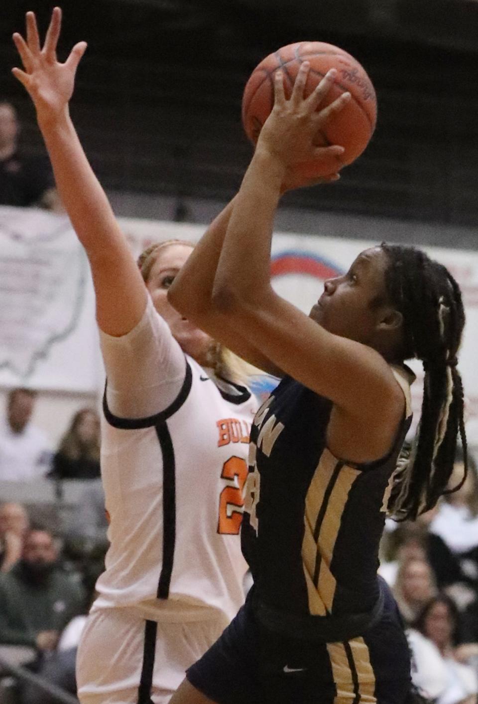 Hoban's Niera Stevens goes up for a shot over Green's Jenna Slates in a Division I district final Feb. 24 at Perry High School.