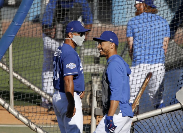 LOS ANGELES, CALIF. - JULY 3, 2020. Dodgers right fielder Mookie Betts chats with manager Dave Roberst during practice at Dodger Stadium on Friday, July 3, 2020. (Luis Sinco/Los Angeles Times)