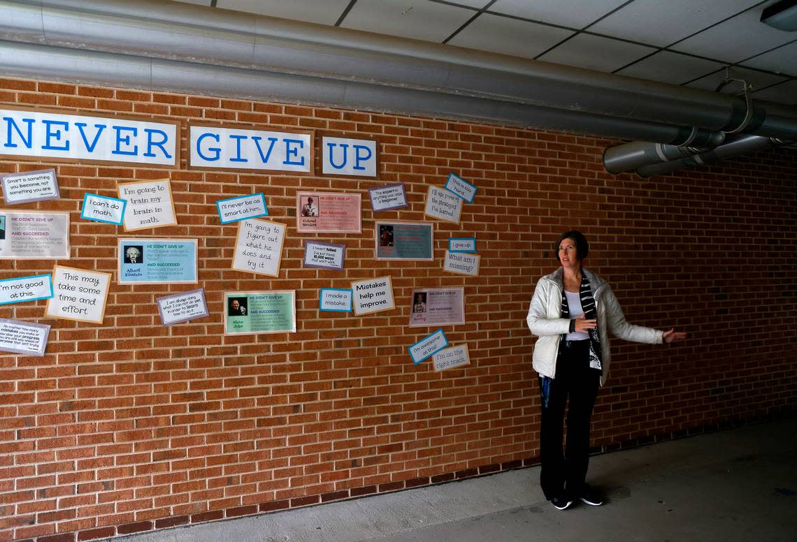 Emily Hardee, assistant principal at Brentwood Elementary School, stands in an outdoor walkway where rainwater pools after storms on Wednesday, Oct. 12, 2022, in Raleigh, N.C. Brentwood Elementary is one of seven schools that would undergo renovations in a $530.7 million bond referendum on the Nov. 8 ballot.