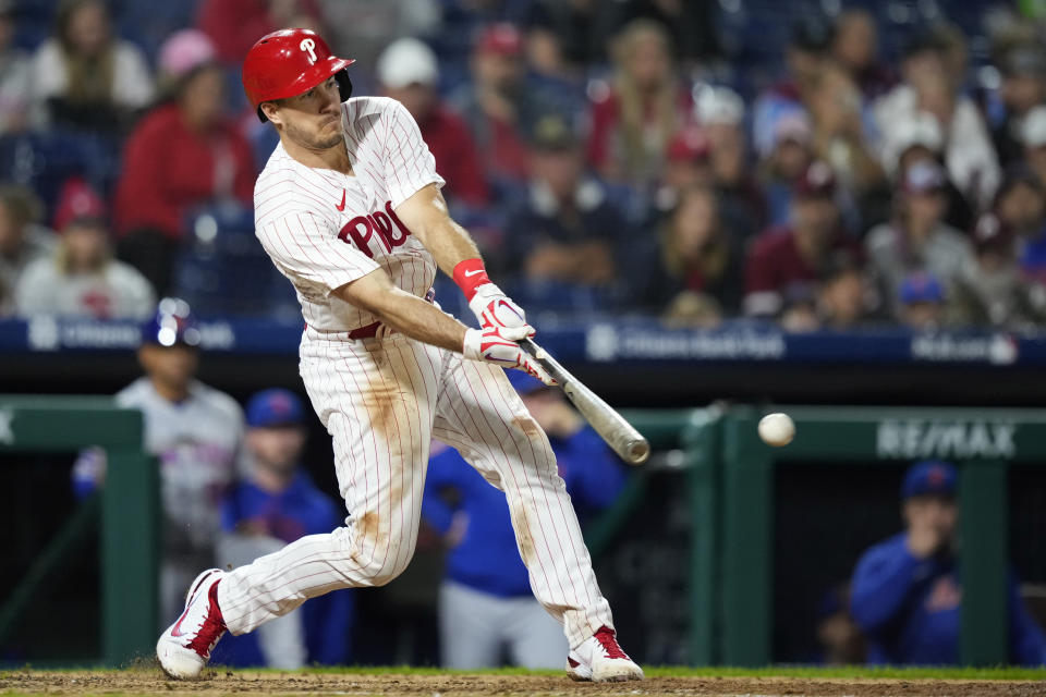 Philadelphia Phillies' J.T. Realmuto hits a two-run single against New York Mets pitcher Jose Butto during the fourth inning of a baseball game, Sunday, Sept. 24, 2023, in Philadelphia. (AP Photo/Matt Slocum)