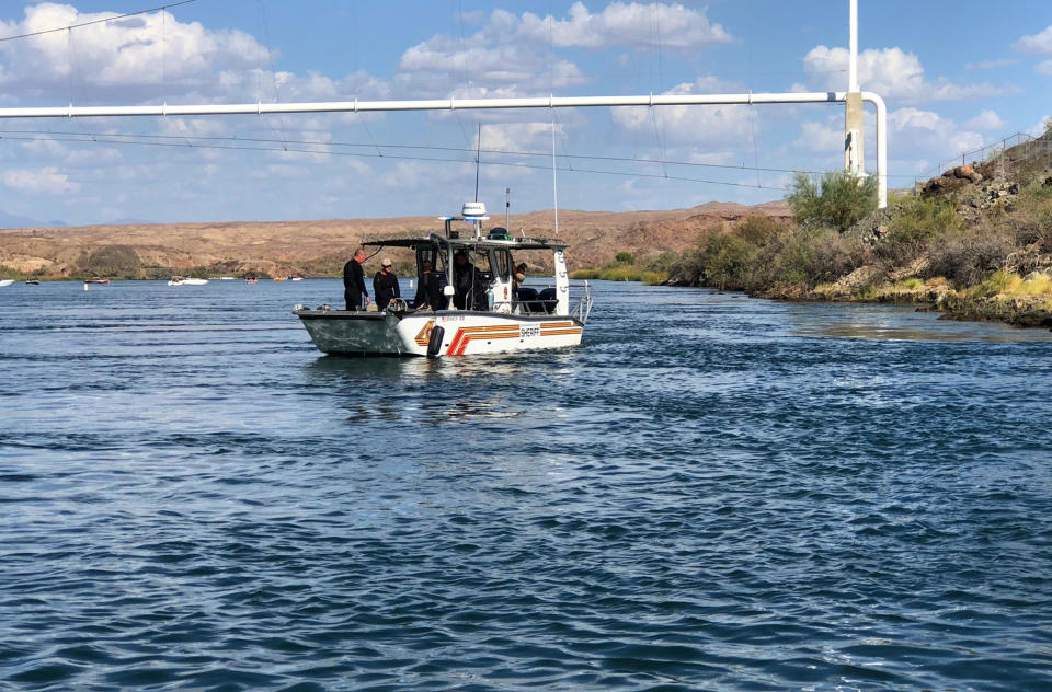 In this photo released by the San Bernardino County, Calif., Sheriff's Office, shows search and recovery operations Monday, Sept. 3, 2018, for three people missing after two boats collided Saturday evening on the Colorado River along the California-Arizona border near Topock, Ariz. The body of a California woman was found Monday, authorities said. A search continued for two other women and one man. (San Bernardino County Sheriff's Office via AP)