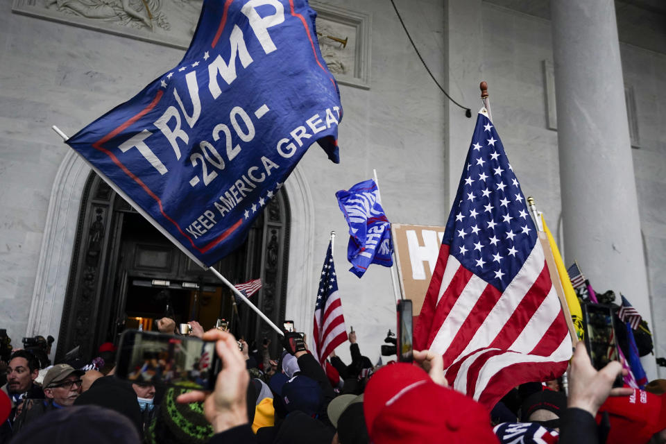 FILE - Rioters loyal to President Donald Trump at the U.S. Capitol on Jan. 6, 2021, in Washington. Liberal groups are trying to end Trump's attempt to return to the White House by arguing that he is no longer eligible to be president after trying to overturn the 2020 election results. (AP Photo/Julio Cortez, File)