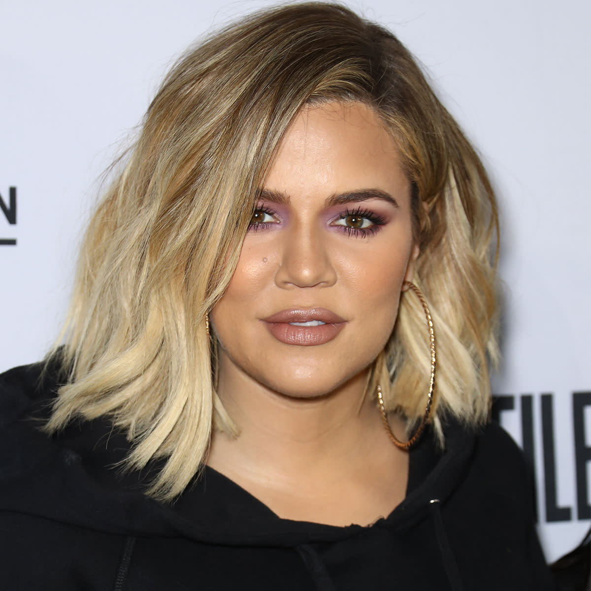 Khloe Kardashian cropped blonde hair black outfit