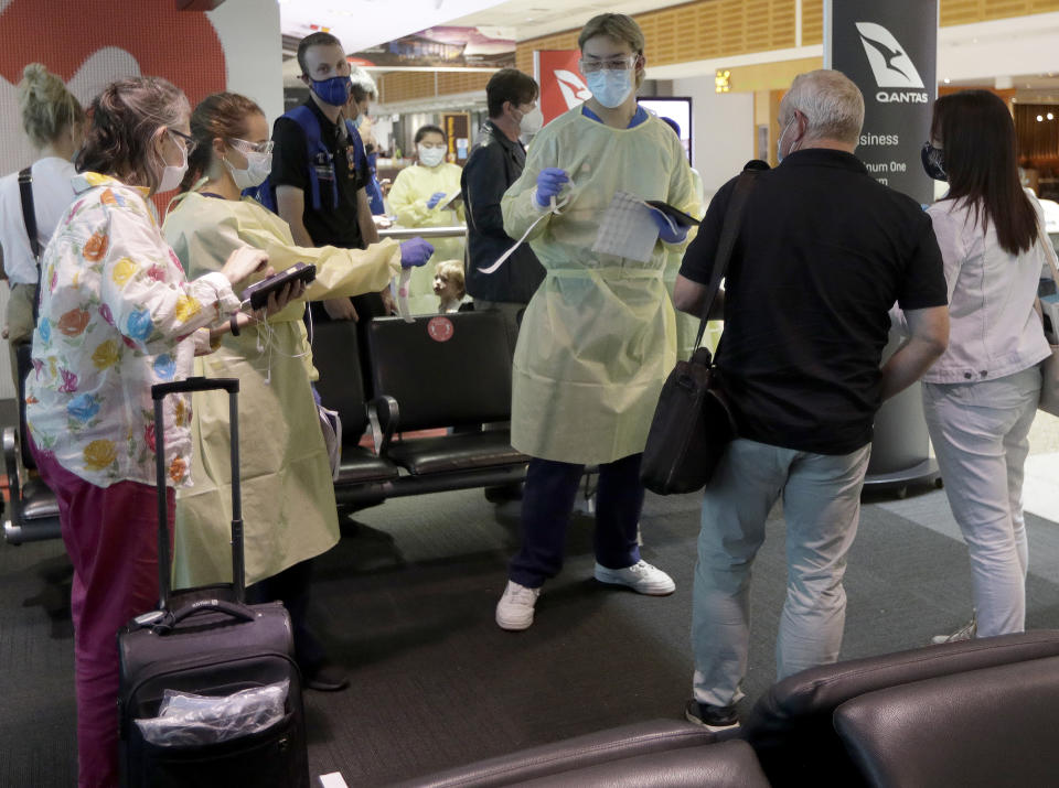 Passengers arriving from Melbourne are screened by health workers at the airport in Sydney.