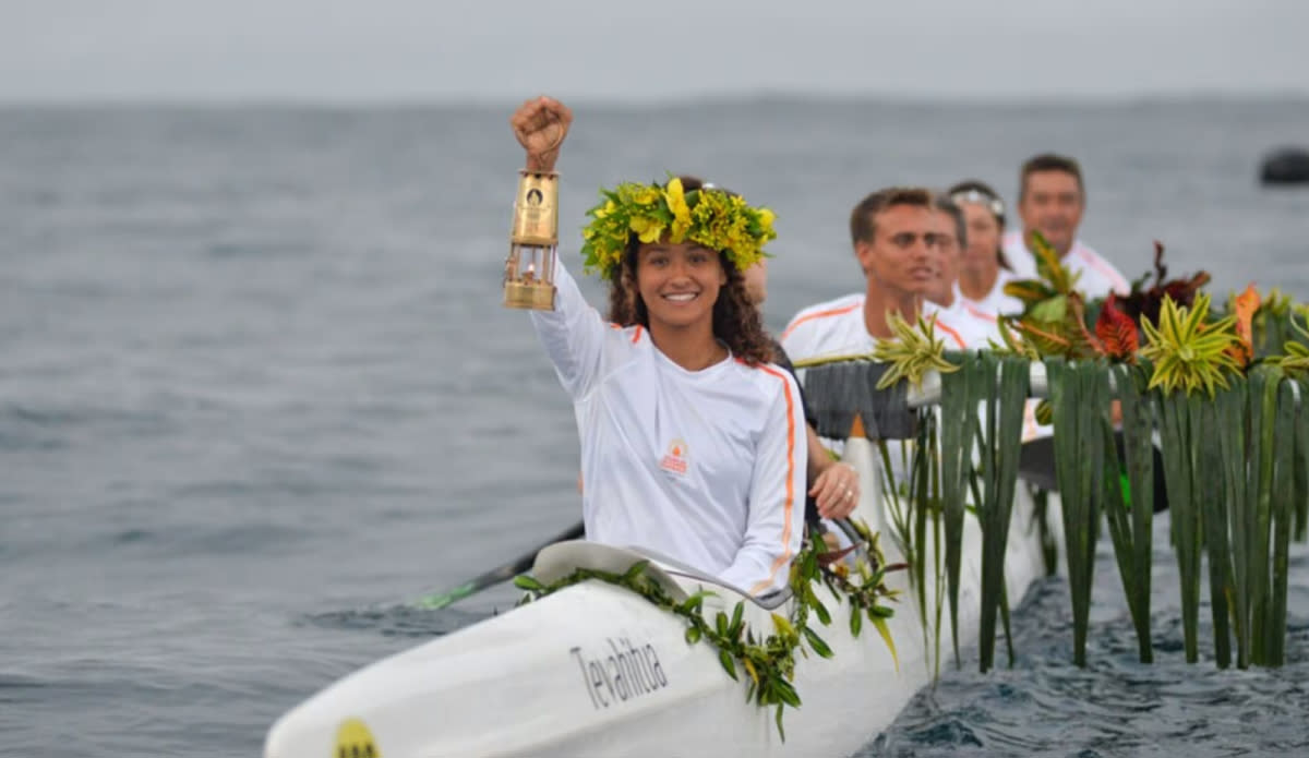 Tahitian surfer Vahine Fierro carrying the Olympic torch. Photo: Olympics.com