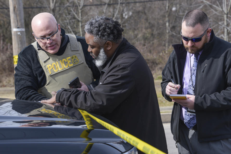 Law enforcement personnel work at the scene of a shooting, Wednesday, Feb. 12, 2020, in Baltimore. Two law enforcement officers with a fugitive task force were injured and a suspect died in the shooting, the U.S. Marshals Service said. (Ulysses Muñoz/The Baltimore Sun via AP)