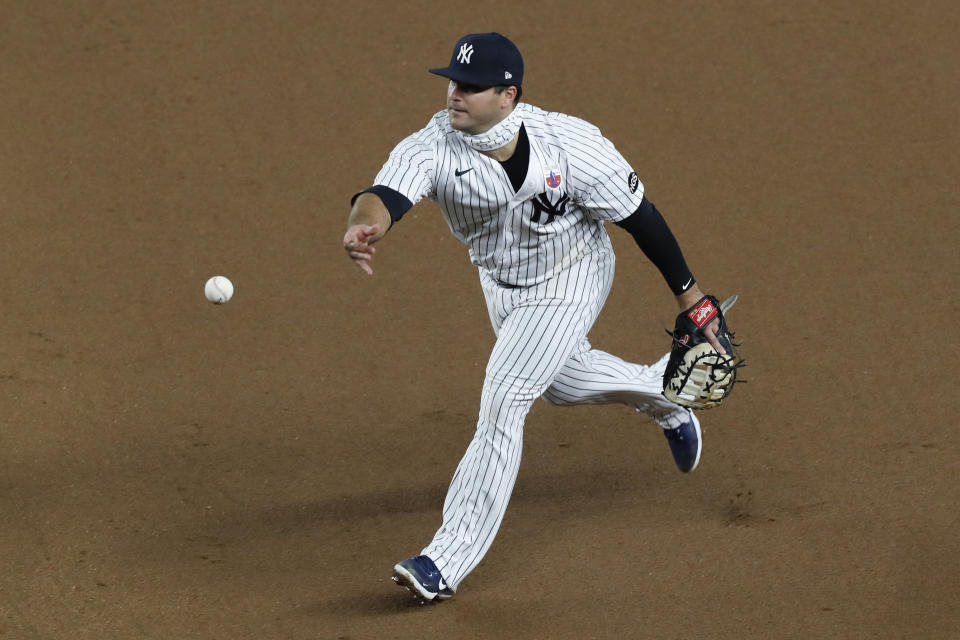 New York Yankees first baseman Mike Ford tosses the ball to pitcher J.A. Happ at first to put out Boston Red Sox's Alex Verdugo during the fifth inning of a baseball game Sunday, Aug. 16, 2020, in New York. (AP Photo/Kathy Willens)