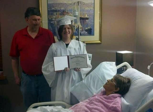 In this Monday, April 21, 2014 photo courtesy of Evie Shumaker, 17-year-old Evie Shumaker, of Newport, Ohio, displays her diploma after a special graduation ceremony in her mother's room at Licking Memorial Hospital in Newark, Ohio. Evie's mother, Melissa Shumaker has late-stage, inoperable pancreatic cancer, and Evie's teachers decided to award her a diploma early so her mother could see her graduate. (AP Photo/Courtesy Evie Shumaker)
