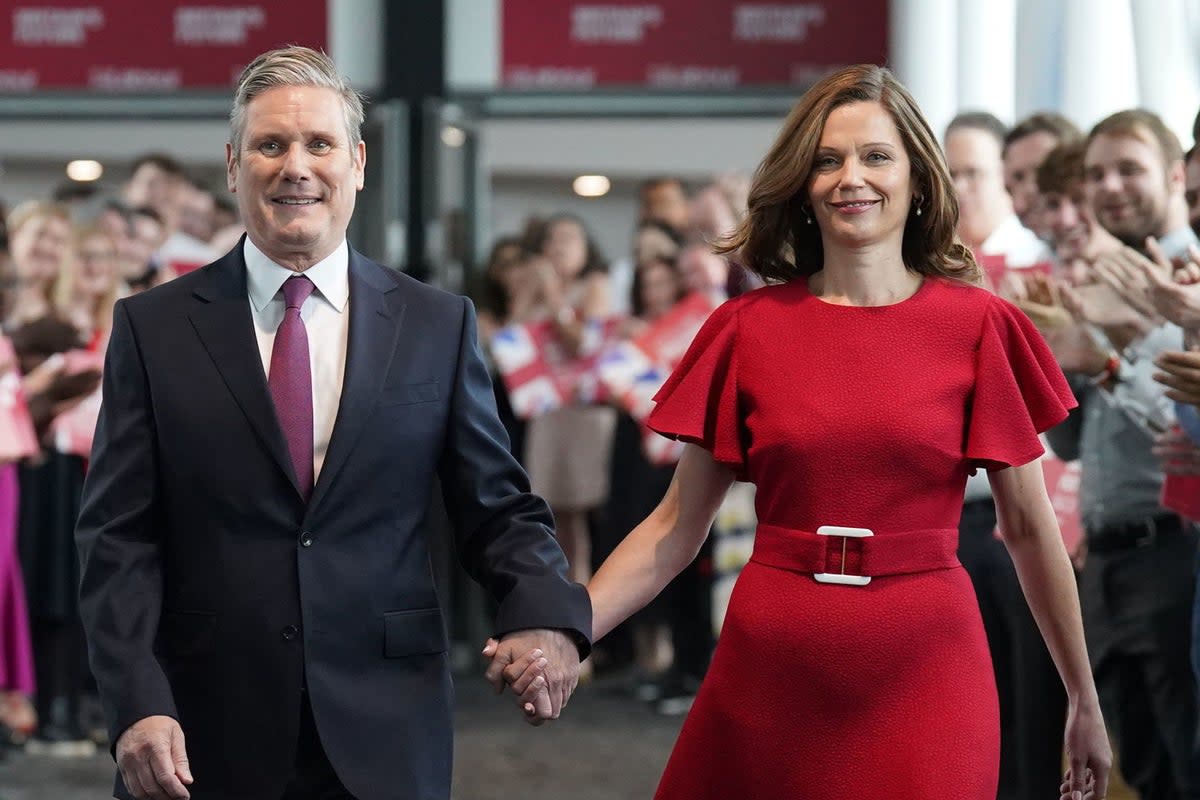 Keir Starmer stepped out in Liverpool with his wife Victoria, who wore a swishy £800 Edeline Lee dress (PA)