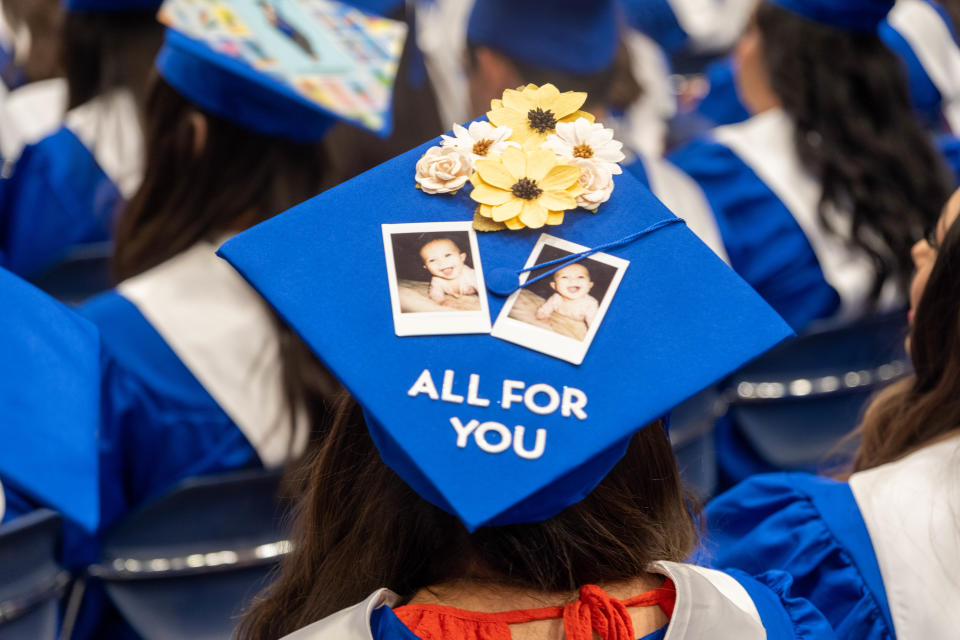 A graduate shows her inspiration for her hard work Saturday at the Amarillo College commencement in downtown Amarillo.