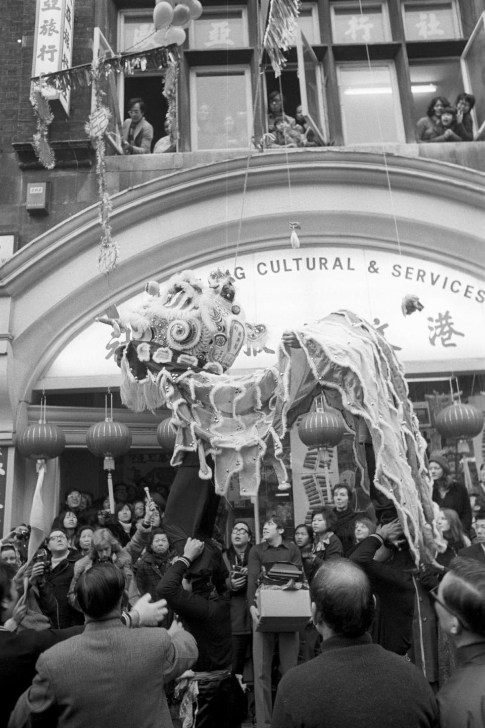 Crowds in Gerrard Street wait for the start of the lion dance, part of the Chinese New Year Festival in 1973 (PA)