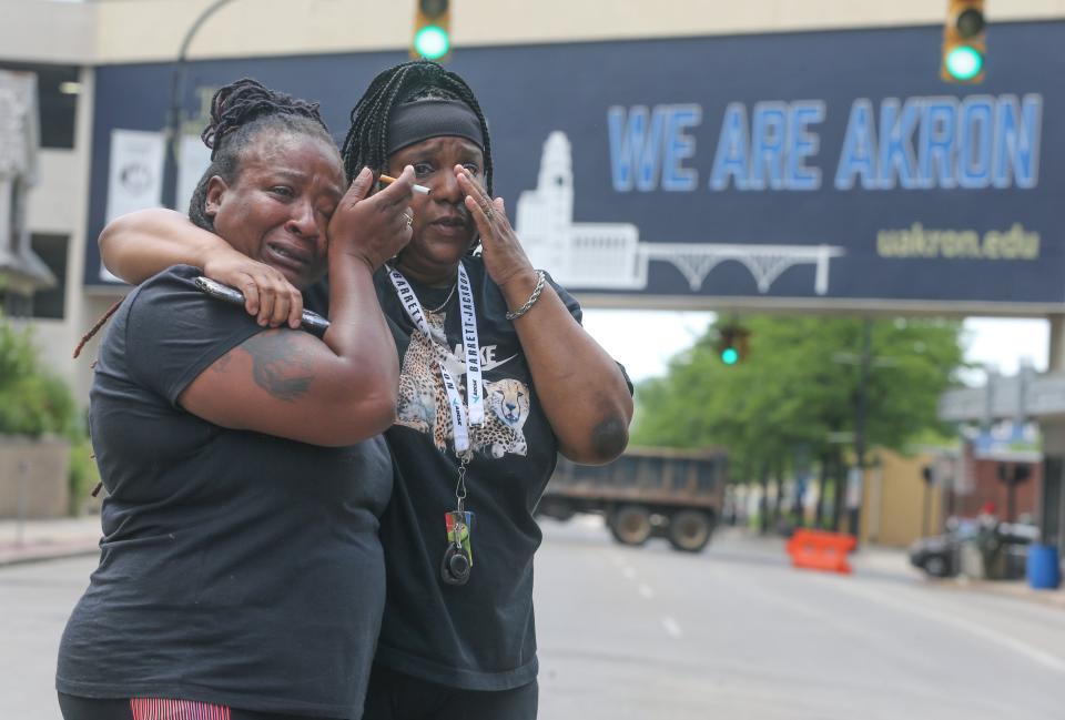 Sandra Dees, left, and Marquita Carter stand tearfully in front of the Harold K. Stubbs Justice Center on Sunday after viewing the bodycam footage of Jayland Walker's fatal shooting by Akron police.