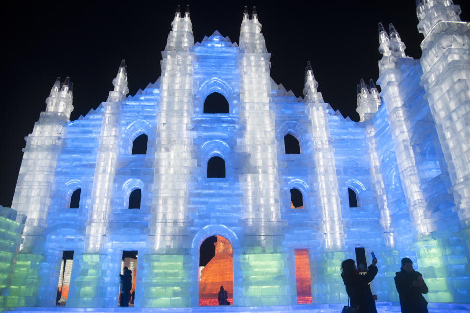 Tourists at the Ice and Snow World park view grand buildings built with crystal-clear ice cubes with colorful lights placed inside on Jan. 5, 2019, in Harbin, China. (Photo: Tao Zhang/Getty Images)