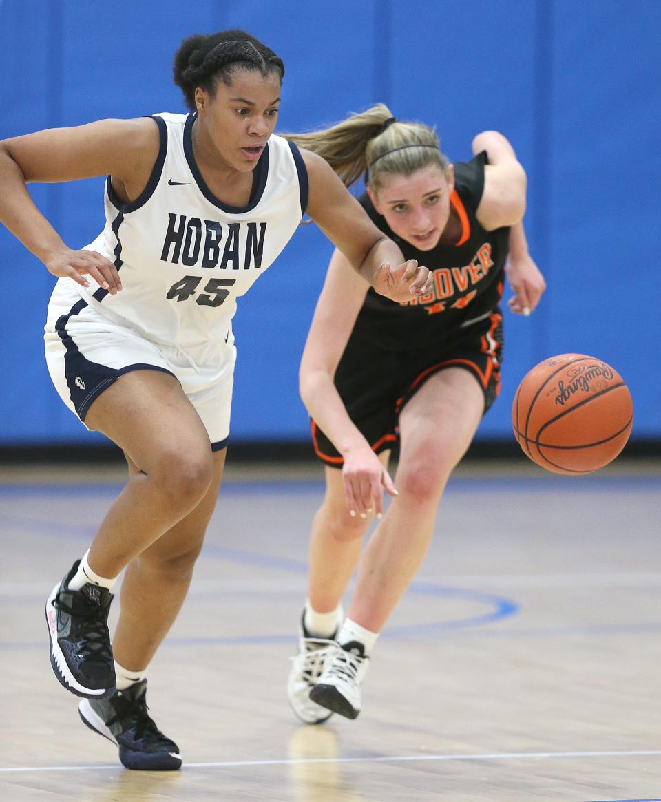 Hoban's Lanae Riley and North Canton's Grace Craig go after a first half loose ball on Friday, Feb.25, 2022 in Ravenna, Ohio, in a Division I District Championship game.