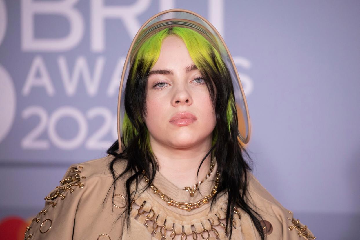 Billie Eilish poses for photographers upon arrival at Brit Awards 2020 in London, Tuesday, Feb. 18, 2020. 