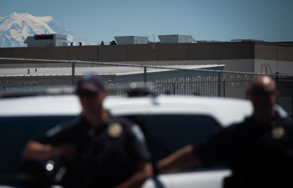 Tacoma Police watch as protesters from various groups including La Resistencia, Coalition of Anti-Racist Whites, Antifa, 3% Washington and Proud Boys clashed with each other outside the Northwest Detention Center in Tacoma, Wash., on Saturday, July 20, 2019.