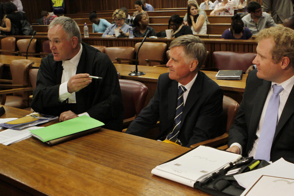 FILE In this file photo taken Thursday, March 28, 2013 the defense team for athlete Oscar Pistorius, led by Barry Roux, left, prepares for a hearing in the Pretoria, South Africa high court opposing the bail conditions of Pistorius who is charged with the shooting death of his girlfriend Reeva Steenkamp. At the start of Pistorius' trial Monday March 3, 2014, prosecutors pressing the murder charge have listed 107 witnesses they're able to call and some will say that the world-famous athlete had a fight with Steenkamp and then intentionally killed her. (AP Photo/Denis Farrell-File)