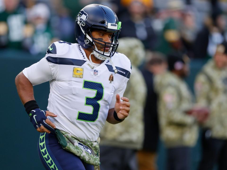 Russell Wilson runs out on the field for a game against the Green Bay Packers.