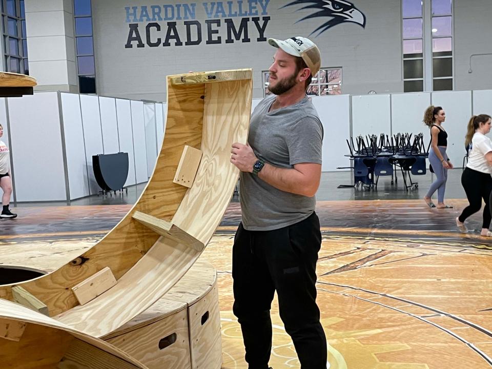 CJ McCrory is a hands-on director as he assembles a large centerpiece representing a clock at Winter Guard practice at Hardin Valley Academy, Monday, Jan. 23, 2023.