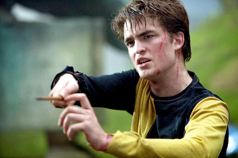 Pattinson as Diggory, holding his wand up