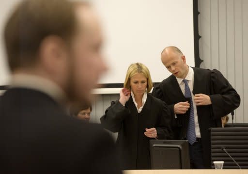 Norwegian right-wing extremist Anders Behring Breivik stands in court on Thursday as prosecutors Inga Bejer Engh and Svein Holden prepare to present their closing arguments against him in the courtroom in Oslo. Breivik, who killed 77 people in Norway last July, should be locked up in a psychiatric ward instead of prison, the prosecution said Thursday