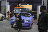 Workers prepare at a Rolls Royce car booth for the upcoming auto show to be held in Beijing, China, Wednesday, April 24, 2024. Foreign automakers have been caught flat-footed in China by an electric vehicle boom that has shaken up the market over the last three years. That has left manufacturers like Volkswagen scrambling to develop new models for a very different market than at home. (AP Photo/Tatan Syuflana)