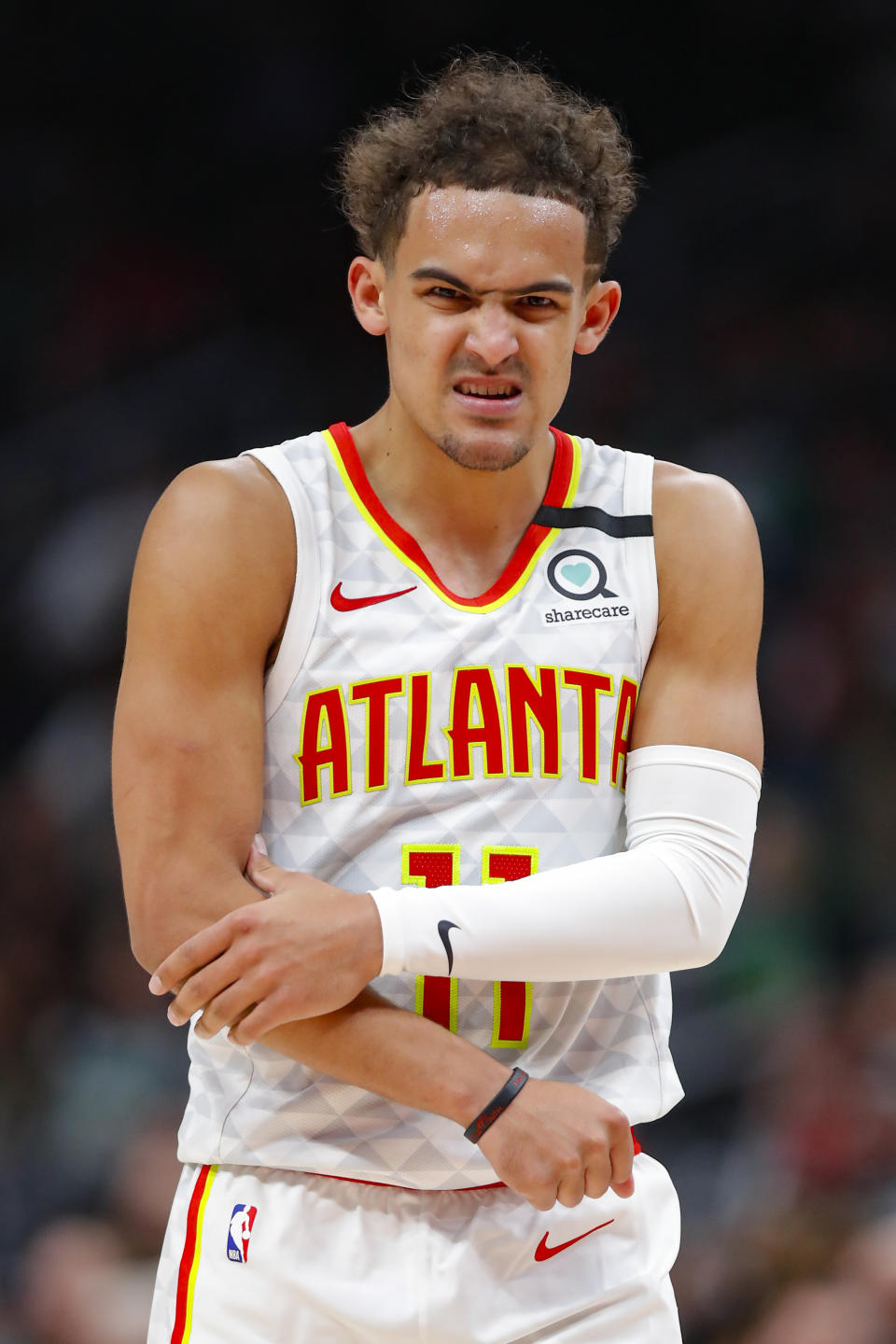 Atlanta Hawks guard Trae Young (11) grabs his arm in pain in the second half of an NBA basketball game against the Boston Celtics on Monday, Feb. 3, 2020, in Atlanta. (AP Photo/Todd Kirkland)