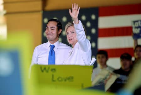 Democratic U.S. presidential candidate Hillary Clinton waves with U.S. Secretary of Housing and Urban Development Julian Castro at her side during a "Latinos for Hillary" rally in San Antonio, Texas October 15, 2015. Castro endorsed Clinton's campaign for president. REUTERS/Darren Abate