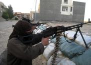 In this Friday, April 11, 2014 photo, masked anti-government gunmen hold their weapons in combat position in Fallujah, 65 kilometers (40 miles) west of Baghdad, Iraq. Al-Qaida-linked fighters and their allies seized the city of Fallujah and parts of the Anbar provincial capital Ramadi in late December after authorities dismantled a protest camp. Like the camp in the northern Iraqi town of Hawija whose dismantlement in April sparked violent clashes and set off the current upsurge in killing, the Anbar camp was set up by Sunnis angry at what they consider second-class treatment by the Shiite-led government. (AP Photo)