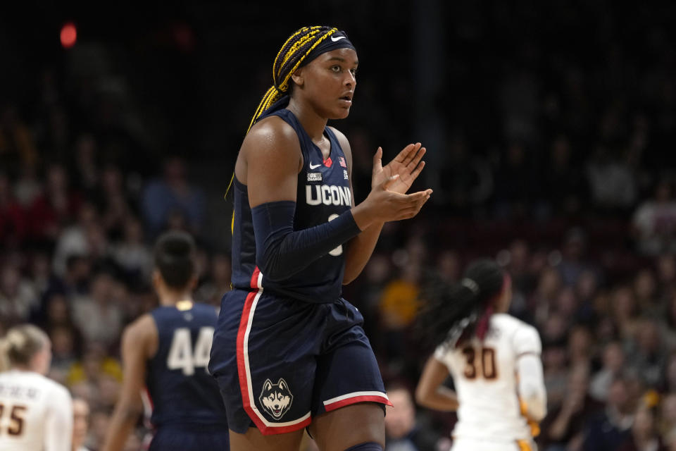 UConn forward Aaliyah Edwards claps during the first half of an NCAA college basketball game against Minnesota, Sunday, Nov. 19, 2023, in Minneapolis. (AP Photo/Abbie Parr)