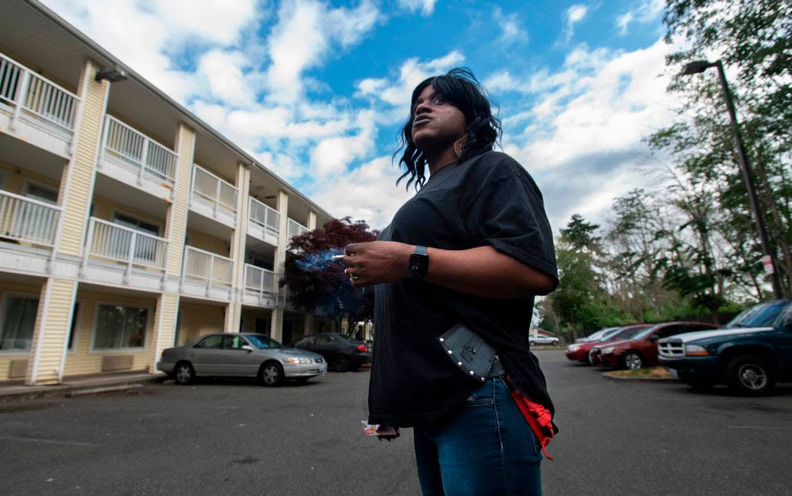 Janelle Wright carries a pair of hatchets on her hip while working her job as head housekeeper at the HomeTowne Studios hotel on Hosmer Street in Tacoma, Washington on July 8, 2022.