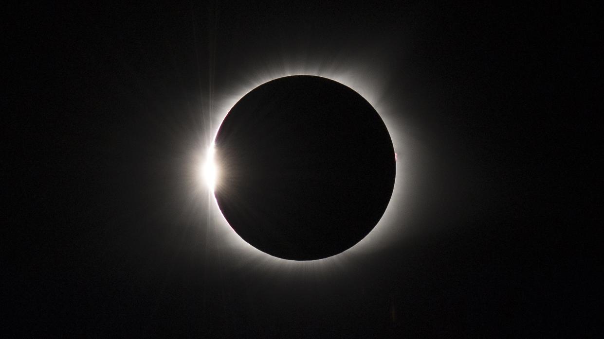  Total solar eclipse on Aug. 21, 2017. appearing as a dark circle surrounded by a halo of white light. 