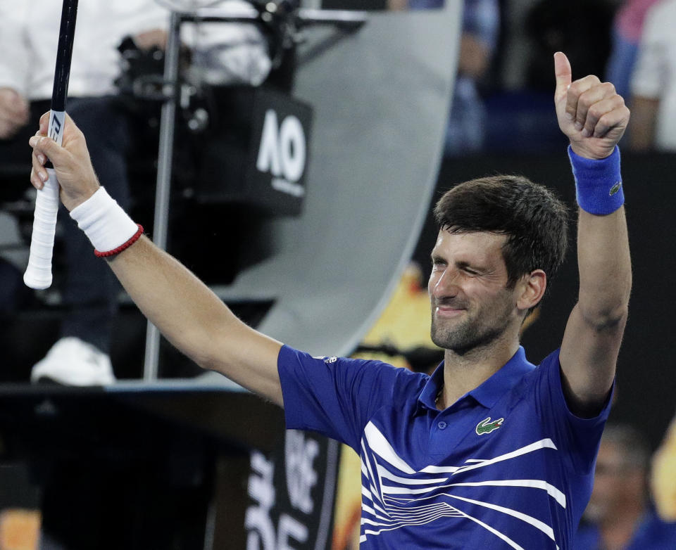 Serbia's Novak Djokovic celebrates after defeating France's Jo-Wilfried Tsonga during their second round match at the Australian Open tennis championships in Melbourne, Australia, Friday, Jan. 18, 2019. (AP Photo/Aaron Favila)