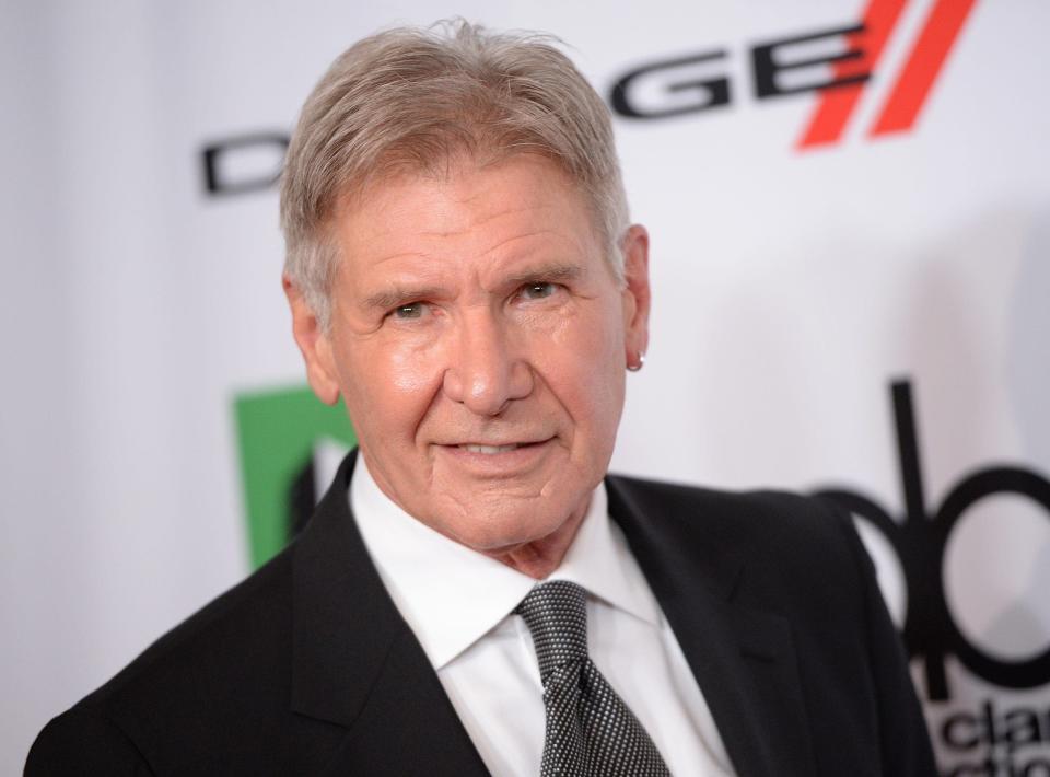 harrison ford on red carpet with hoop earring