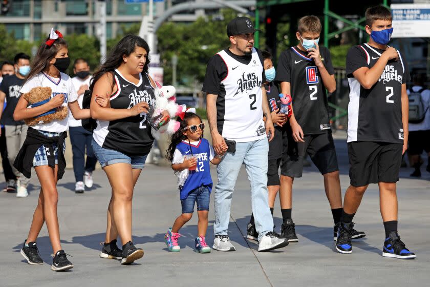 LOS ANGELES, CA - JUNE 18: Ramon Aguilar, center, of Yucaipa, with family from left, daughter Iris, 10, wife Sherleey (cq), daughter Mia, 4, and sons Yazit, 12, Riley, 13, and Noah, 15, make their way to the arena to watch the Los Angeles Clippers game six NBA Western conference playoff game against the Utah Jazz at the Staples Center on Friday, June 18, 2021 in Los Angeles, CA. (Gary Coronado / Los Angeles Times)