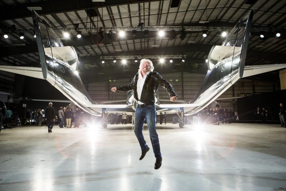 Sir Richard Branson leaping for joy in front of WhiteKnightTwo mothership