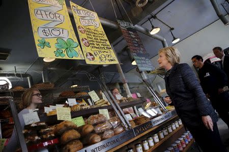 U.S. Democratic presidential candidate Hillary Clinton looks at the menu as she visits Avalon coffee shop during a campaign stop in Detroit, Michigan, March 8, 2016. REUTERS/Carlos Barria