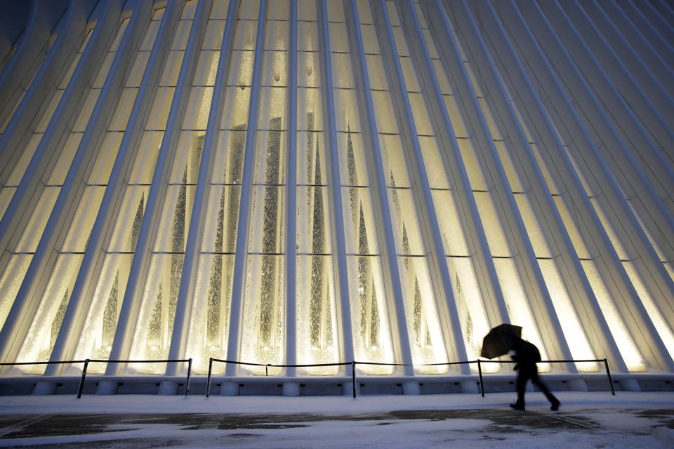 <p>A man makes his way through wind and snow past the Oculus of the World Trade Center Transportation Hub, Thursday, Feb. 9, 2017, in New York. A powerful, fast-moving storm swept through the northeastern U.S. Thursday, making for a slippery morning commute and leaving some residents bracing for blizzard conditions. (Photo: Mark Lennihan/AP) </p>