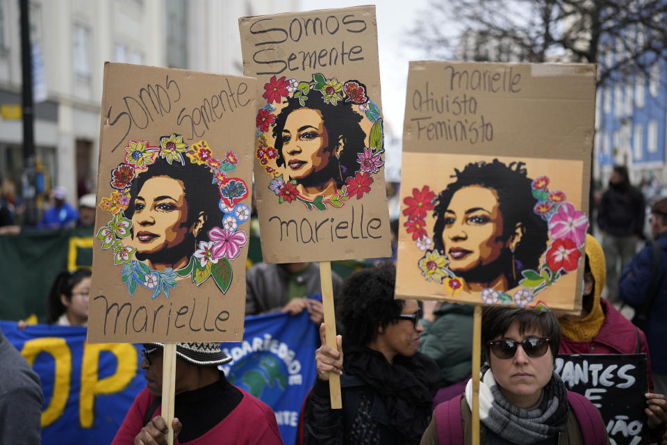 FILE - People carry posters with images of slain Brazilian councilwoman Marielle Franco during a demonstration against racism, in Lisbon, Portugal, Feb. 24, 2024. The 38-year-old stood out as one of the only Black, bisexual women in politics and the abrupt end of her rise shook Brazil with mass protests that echoed around the world. (AP Photo/Armando Franca, File)